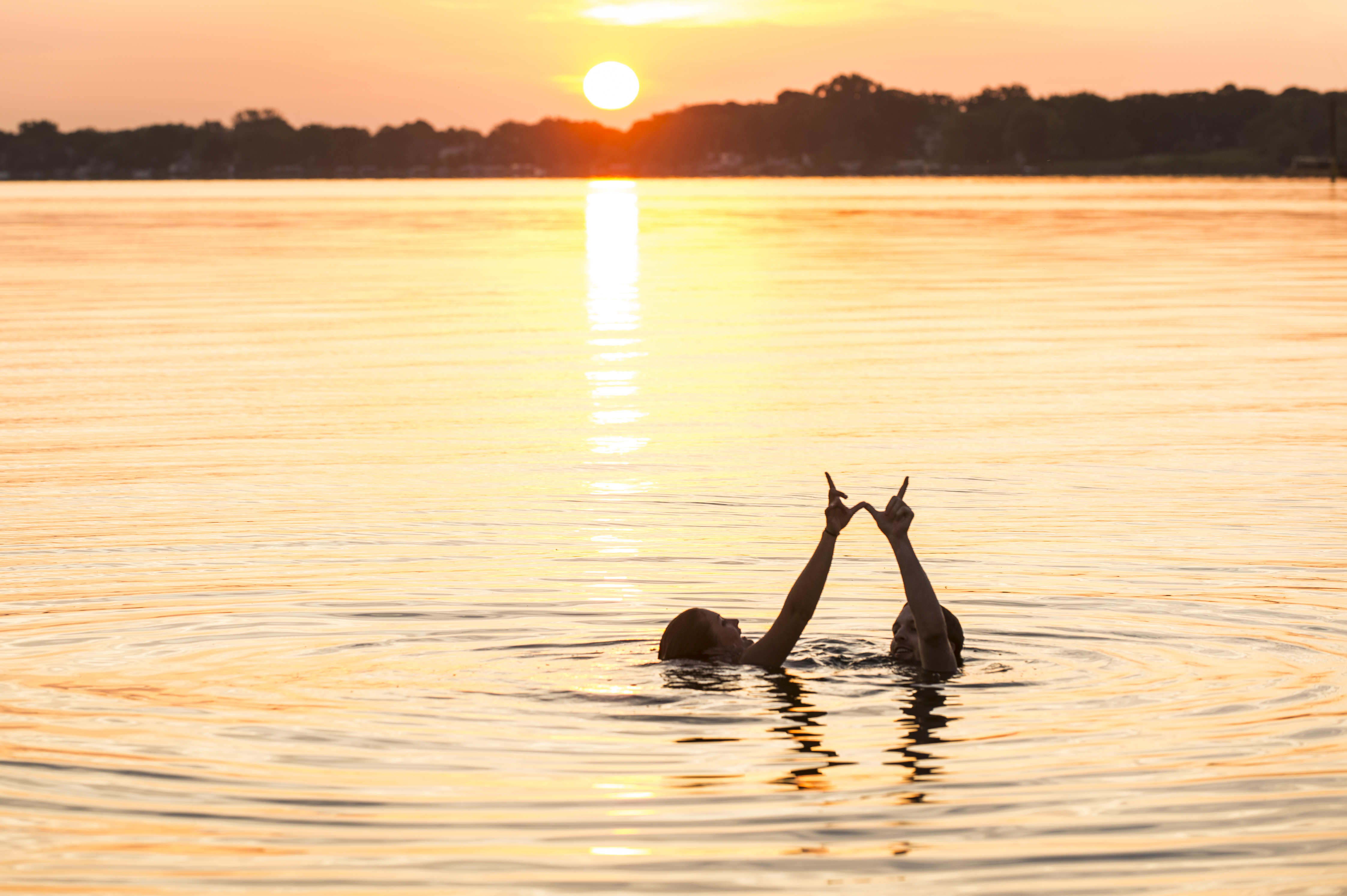 People swimming at the Terrace pier at sunrise