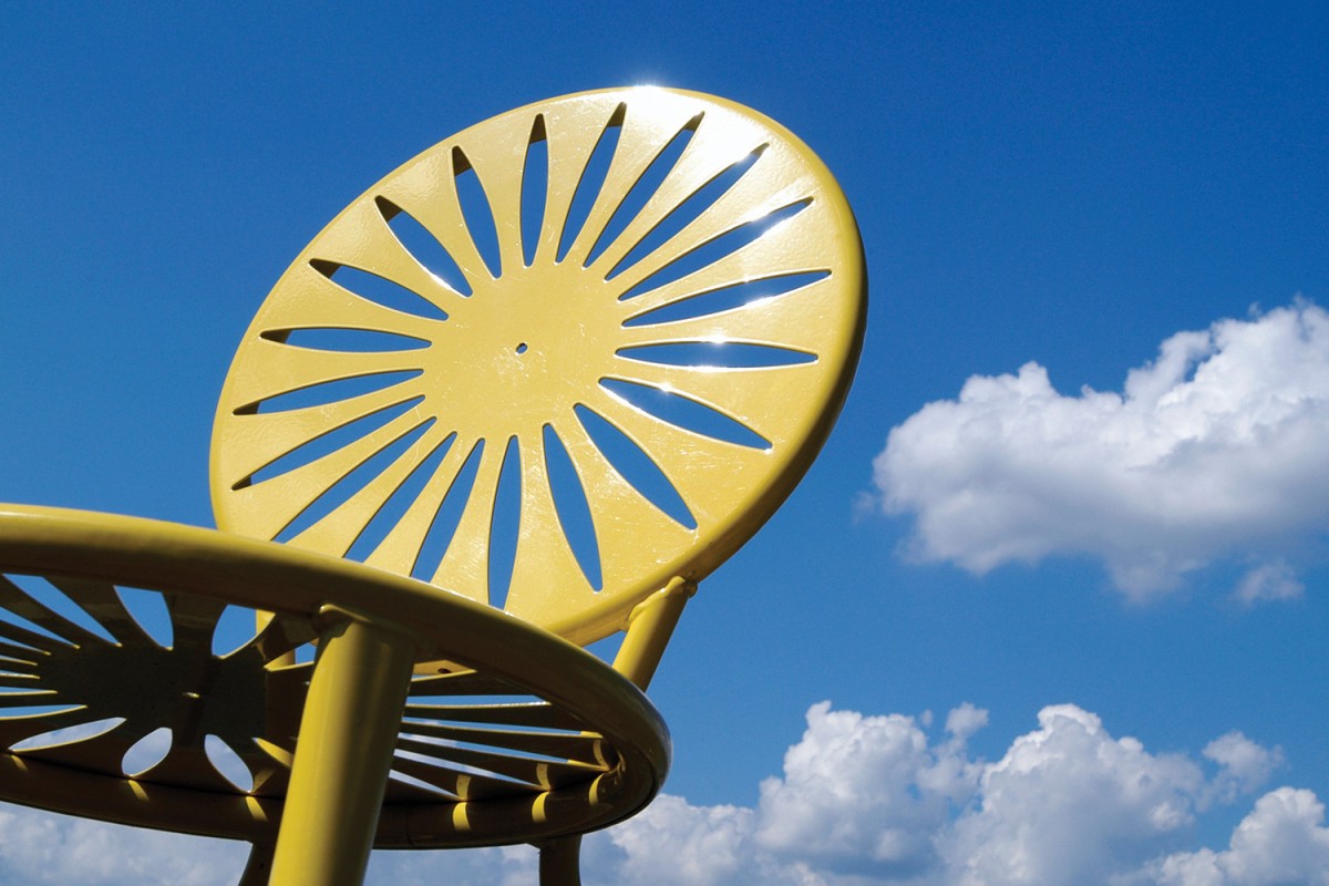 Yellow Wisconsin Union Terrace chair with the sky in the background